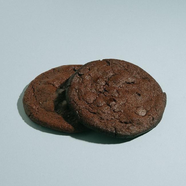 Vegan Double Chocolate Cookie · No joke. These cookies are the epitome of soft, gooey, fudgy, chocolatey goodness. Double dose of fair – trade chocolate and a chewy sweet and salty dough create a beautiful marriage. Close your eyes, you would not know it was Vegan.