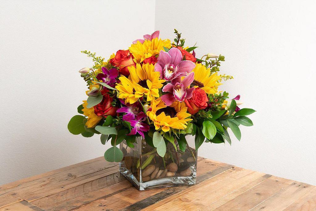 Celebration Arrangement in a Vase · This vibrant arrangement adds a celebratory feel to all events and festivities!

-- Picture represents the Large version of this arrangement --

Seasonal options will vary throughout the year and depending on location. Our florist will provide the best available flowers for your order!