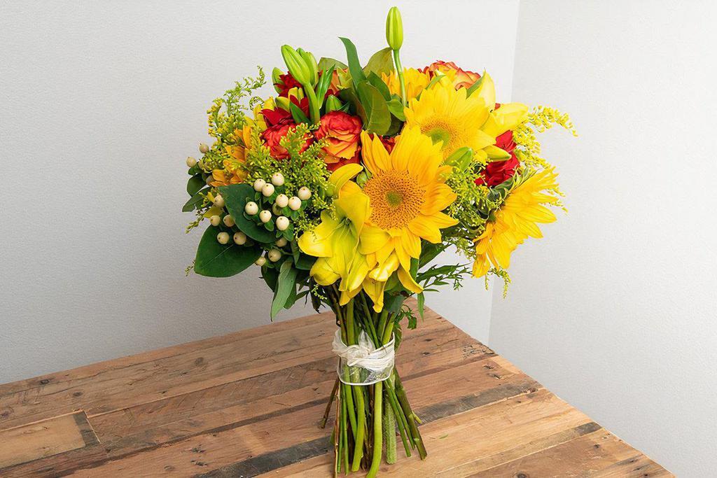 Yellow, Orange, Red Wrapped Bouquet · Seasonal options may vary throughout the year and depending on location. Our florist will provide the best available flowers for your order!