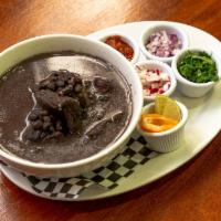 FRIJOL CON PUERCO · Black Bean soup with pork, tomato salsa, radish, onion