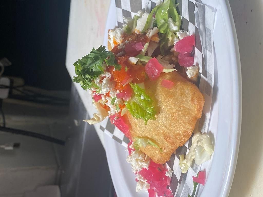 EMPANADAS · Lightly fried masa tortilla rolled into an empanada stuffed with your choice of meat. Topped with cabbage, pickled red onion, tomato sauce and queso fresco.
