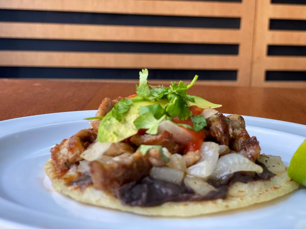 CARNITAS TACO · Refried black beans, onions, cabbage, avocado and tomato sauce. 