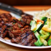 Steak Tips · Hand-cut marinated sirloin tips served over caramelized onions with mashed potatoes and fres...