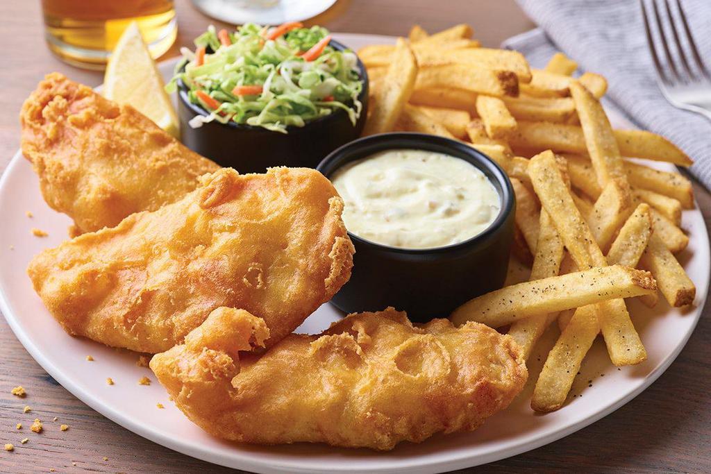New England Fish + Chips · Golden, crispy-battered fish fillet with fries.  Comes with our signature coleslaw, tartar sauce and a lemon wedge.