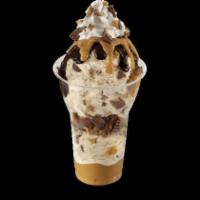 Reese's Peanut Butter Cup Sundae · 3 scoops of Reese's peanut butter cup ice cream layered with Reese's peanut butter sauce, ch...