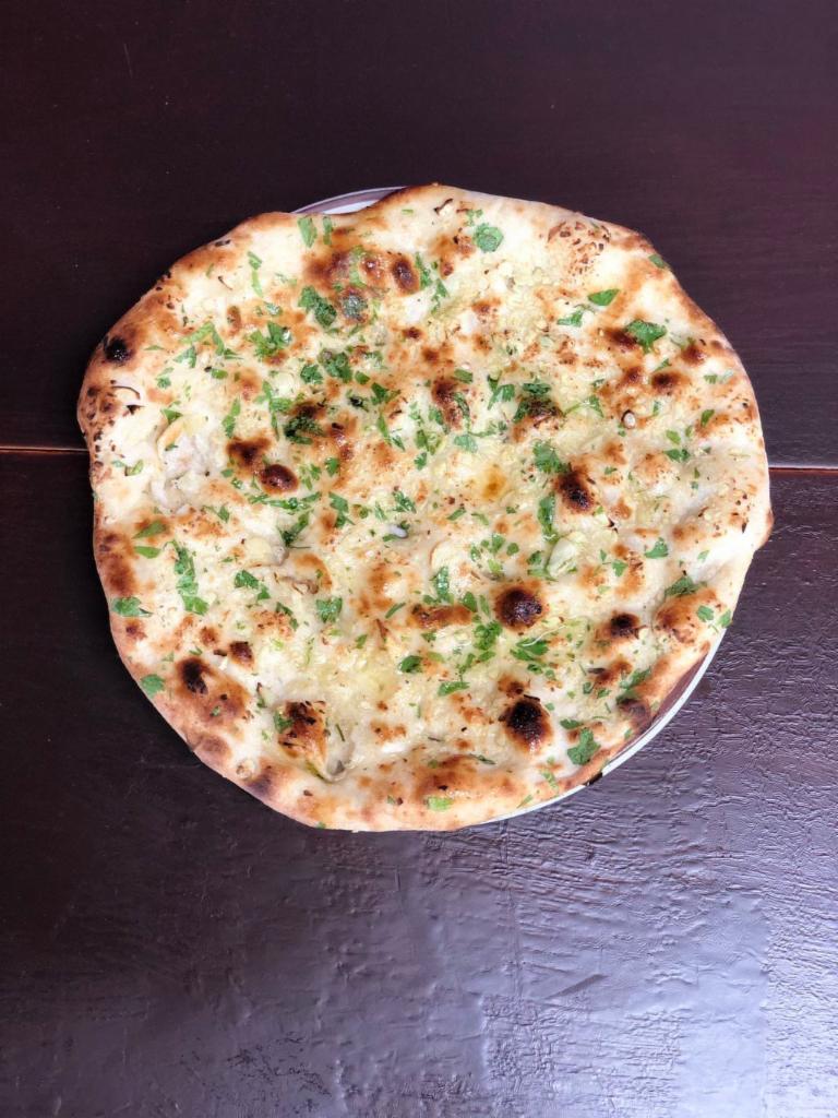 Garlic Naan 2Pcs · Specialty Fresh & Finest Garlic Naan Bread, freshly baked in Tandoor with Garlic & herbs.