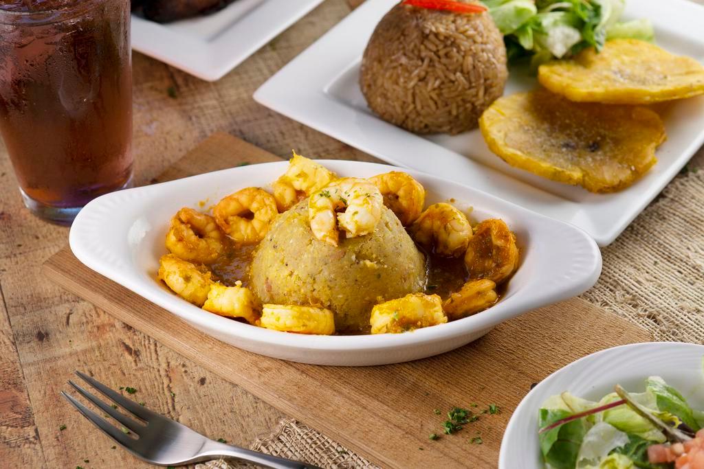 Monfongo with Shrimps · Traditional Puerto Rican mofongo with a twist - Deep fried green plantains & then mashed with chicharron, garlic, butter, EVOO & spices. Served with our homemade Sofrito & Coconut milk sauce with shrimps. Delish!
