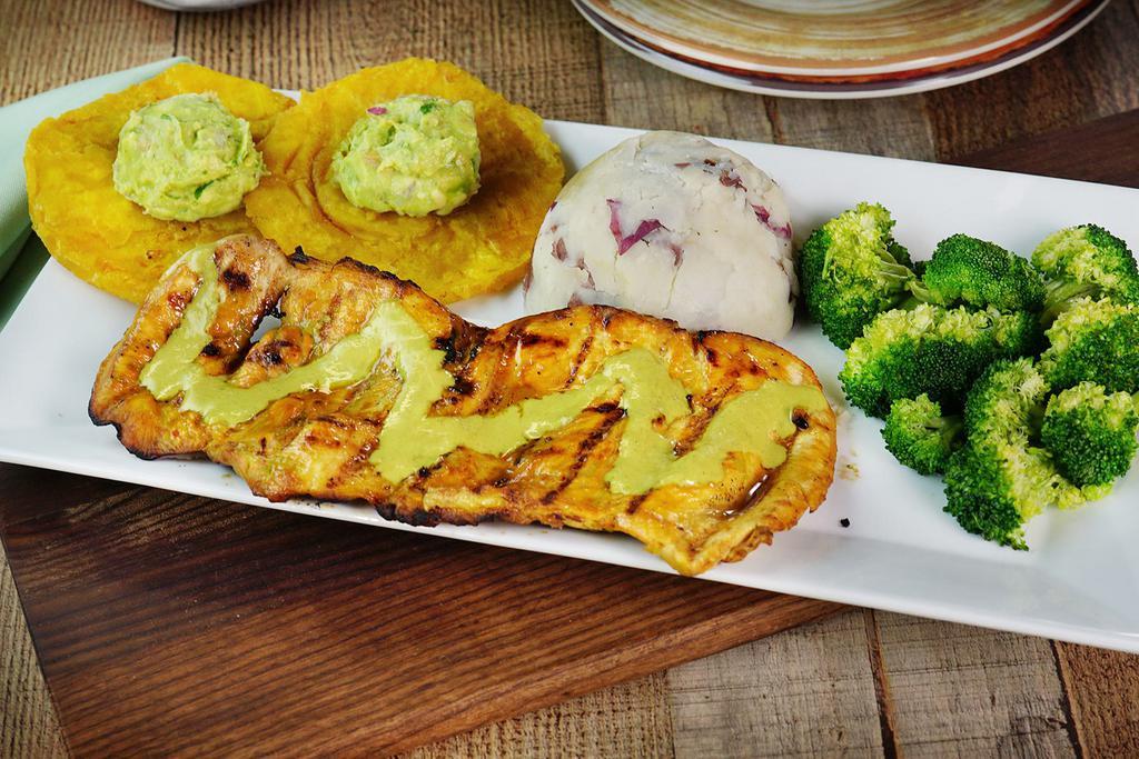Pollo Velez · Grilled chicken churrasco served with mashed potatoes, tostones with guacamole & broccoli. Amazing combination of flavors!