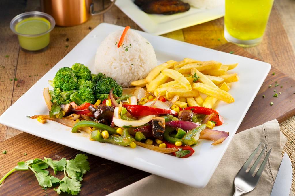 Vegetable Saltado · Mushrooms, onions, peppers, broccoli, corn & cilantro sauteed in an organic soy sauce, served with rice & french fries