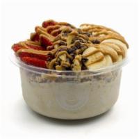 Nica Bowl · Banana blend topped with granola, banana, cacao nibs, walnuts, strawberry, and peanut butter...
