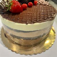 Triple Chocolate Mousse · White, Milk and dark chocolate mousse with chocolate sponge cake.