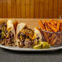 Philly Cheese Steak Sandwich · Peppers, onions, Monterey cheddar, and served with fries.