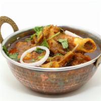 Goat Curry · Mutton cooked in traditional Andhra style with homemade spices. Served with Rice 