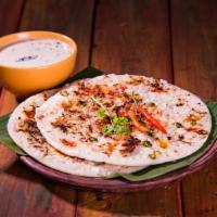 Uttappam · Pancakes made of fermented batter of rice and lentil and topped with mixed vegetables and on...