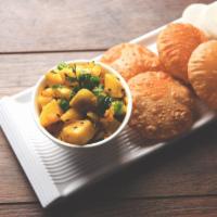 Poori Masala · Puffy bread served with masala on the side.