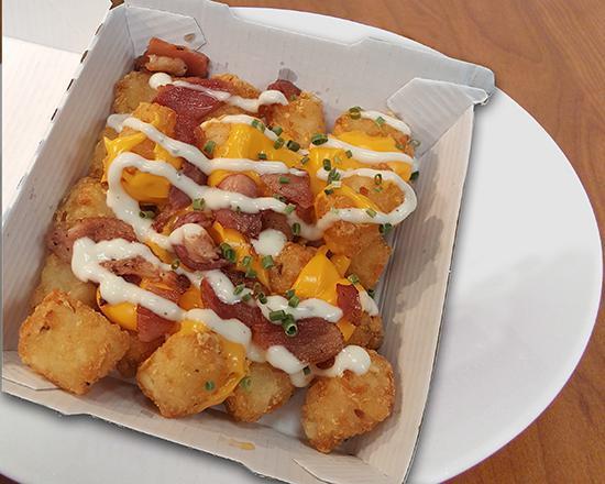 Loaded Tater Tots · Crispy, golden tater tots loaded with all the goods. Cheddar cheese, ranch, bacon, and chives. Nothing is greater than a loaded tater.
Reg: 592 cal.  LG: 1006 cal. 