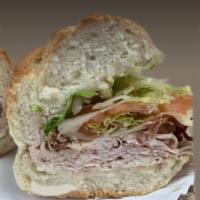 A2. Ovengold Turkey and Swiss with Bacon Sub Lunch · Cured pork. A long sandwich on a roll.
