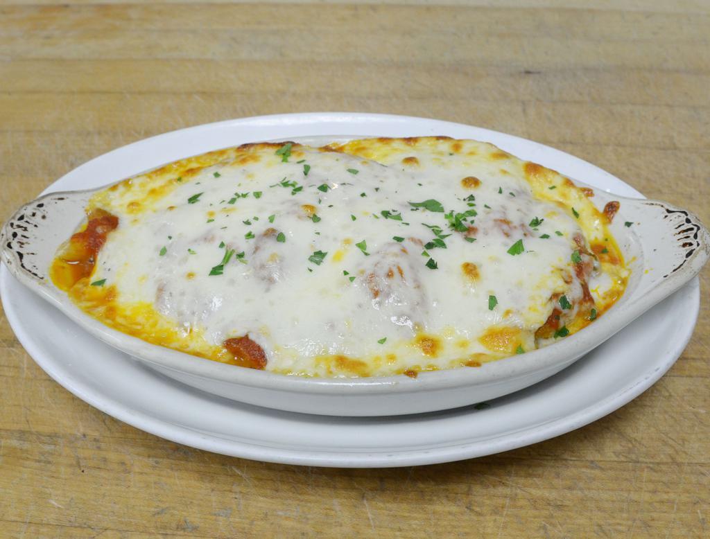 Eggplant Parmigiana · Homemade breaded eggplant cutlets, baked in tomato sauce and topped with mozzarella.