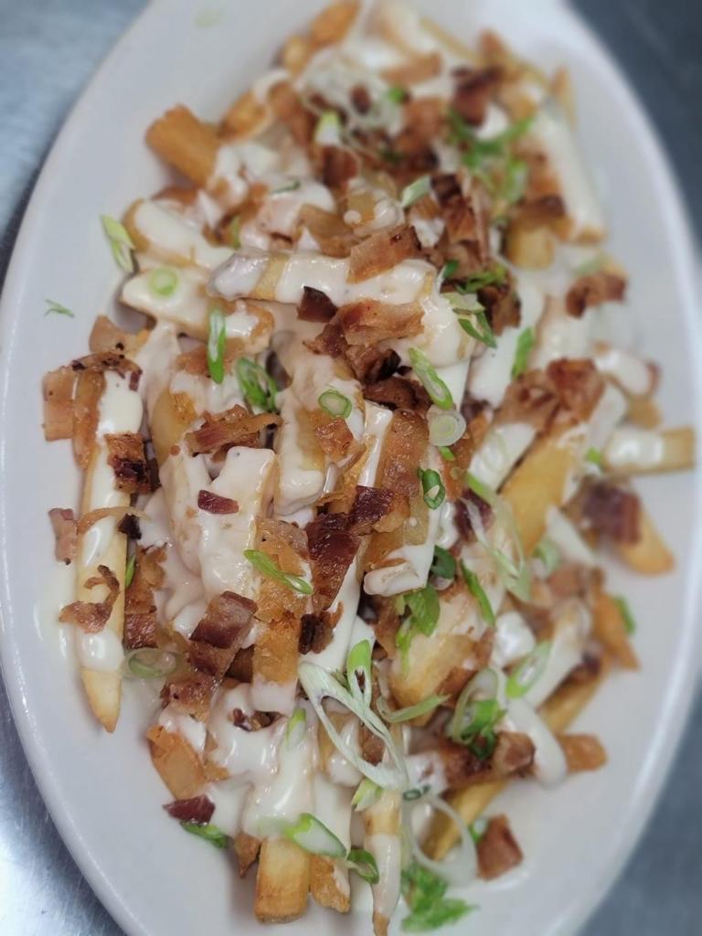Loaded Fries · Applewood smoked bacon, our white 4 cheese sauce, smoked mozzarella topped with scallions.
