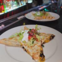 Grilled Chicken Quesadilla · Soft corn tortilla, melted monterey jack cheese, lettuce, sour cream and pico de gallo.