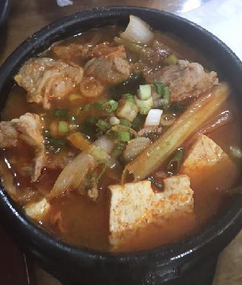 15. Kimchi Jjigae · Our kimchi soup contains various of vegetables, tofu and pork. Spicy. 