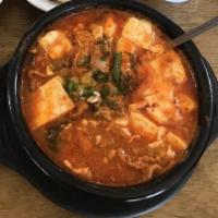 23. Dubu Jjigae · Spicy firm tofu soup contains various of vegetables and it's topped with scallions. Spicy.