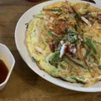 46. Seafood Pancake · Seafood pancake contains various of seafood like squid, shrimp, scallops, egg and oysters.