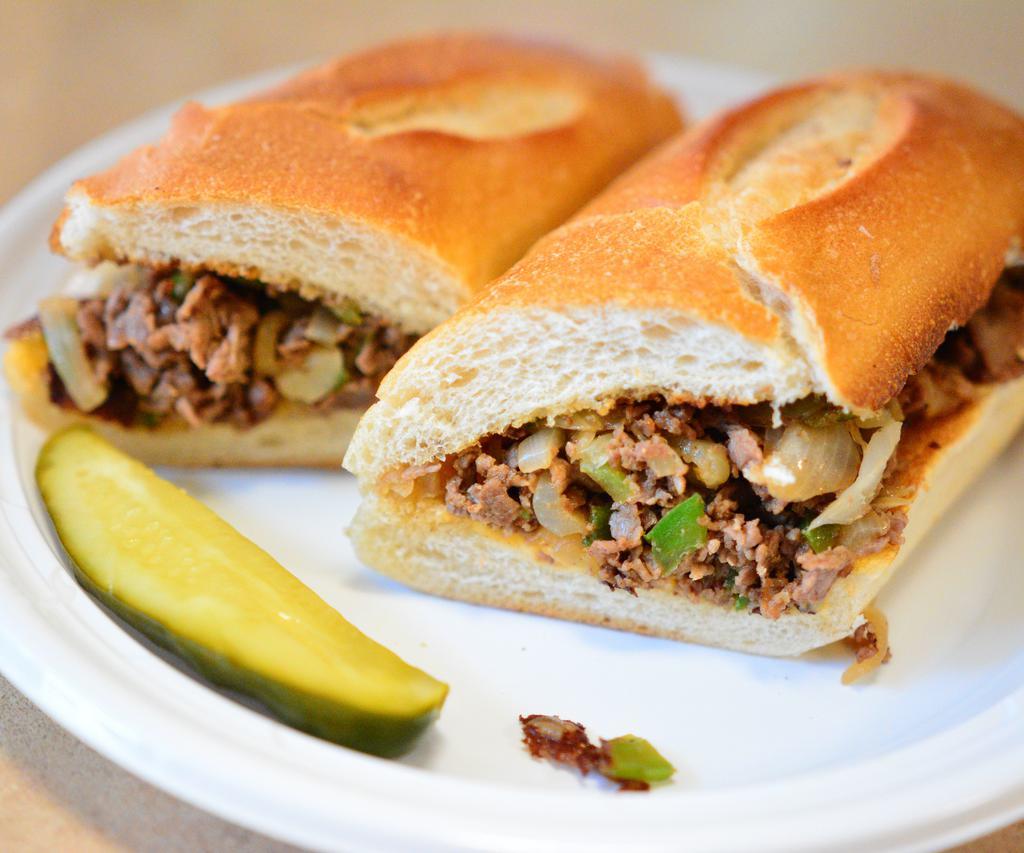 Philly Cheese Steak Sandwich · Premium shredded beef served on hero with melted American cheese. Chopped onions and green peppers.