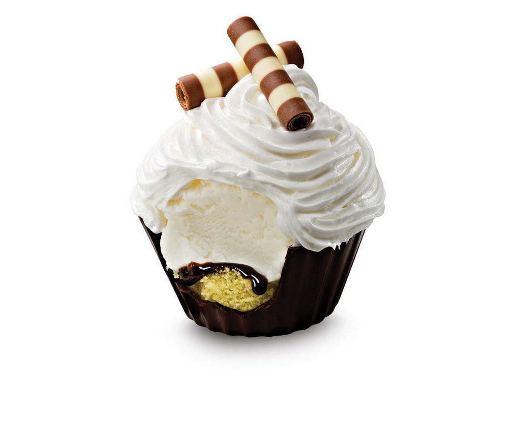 Sweet Cream Cupcake · a rich chocolate cup filled with a layer of yellow cake, fudge and sweet cream ice cream topped with fluffy white frosting and milk and white chocolate curls