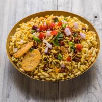 Minakshi’s Bhelpuri · Savory puffed rice with crispy chickpea noodles, fresh onions, cilantro, mint chutney and sw...