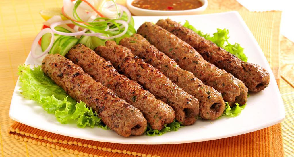 Chicken Seekh Kabab · Oven-baked minced chicken skewers seasoned with onion, garlic, coriander, cumin and exotic
spices.