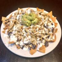 Carnitas Nacho · Fried pork. Served with black beans, sour cream, cheese and guacamole.