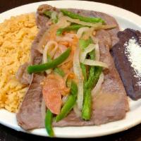 Bistec Encebollado · Grilled steak with onions. Served with rice and beans.