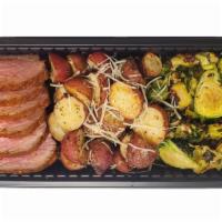 Tri Tip Family Meal · 1 lb. Santa Maria Tri Tip, 8 oz. Roasted Brussels Sprouts, 1 lb. Scalloped Potatoes.