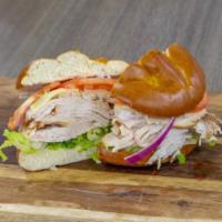 Hand-Carved Turkey Sandwich · A touch of virgin olive oil, hand-carved turkey, tomato, red onion, with your choice to chee...