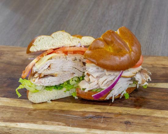 Hand-Carved Turkey Sandwich · A touch of virgin olive oil, hand-carved turkey, tomato, red onion, with your choice to cheese and additional toppings.