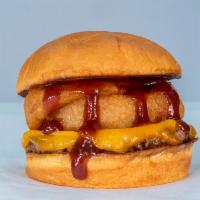 The Onion Ringer · impossible patty, cheddar cheese, onion rings, BBQ sauce served on King's Hawaiian roll.
