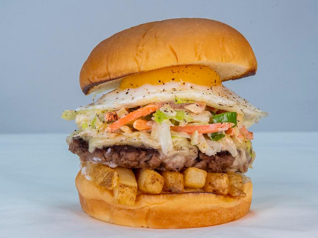 Slaw Burger · impossible patty, white American cheese, fries, Haus slaw, fried egg, and mayo. Hormone and antibiotic free beef served on King's Hawaiian roll.