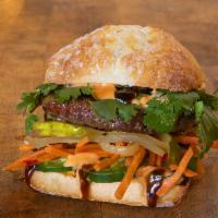 TAKE BÁNH MÌ · impossible patty, cilantro, jalapenos, hoisin sauce, spicy veganaise, pickled vegetables; se...