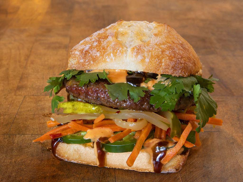 TAKE BÁNH MÌ · impossible patty, cilantro, jalapenos, hoisin sauce, spicy veganaise, pickled vegetables; served on a vegan ciabattta roll