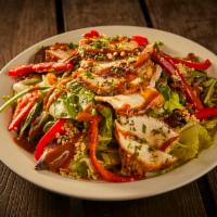 Thai Chicken Salad · Fresh greens layered with red bell peppers and grilled chicken, topped with crushed peppers,...