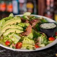 BLT Salad with Avocado · A bed of crispy romaine lettuce smothered in bacon, then topped with sliced tomatoes and fre...
