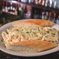 Alfredo Chicken · Grilled chicken breast with penne pasta tossed in our famous creamy Alfredo sauce and finish...
