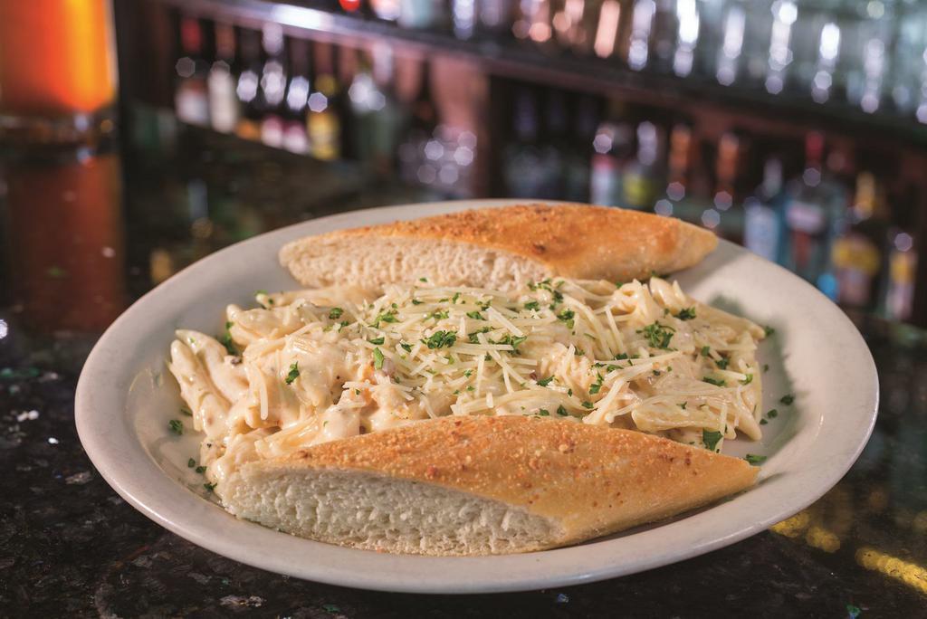 Alfredo Chicken · Grilled chicken breast with penne pasta tossed in our famous creamy Alfredo sauce and finished with Parmesan cheese.