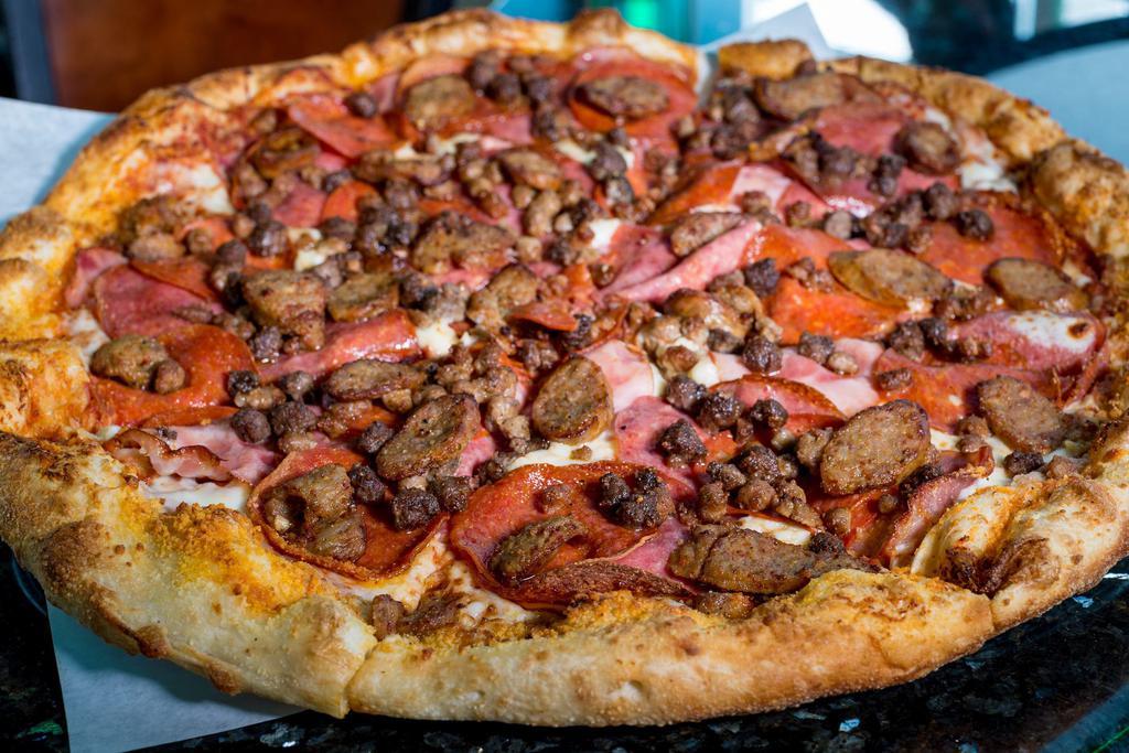 Sch'meat'za Pizza · Canadian bacon, crumbled Italian sausage, Genoa salami, pepperoni, ground beef, bacon and sliced spicy Italian link sausage.