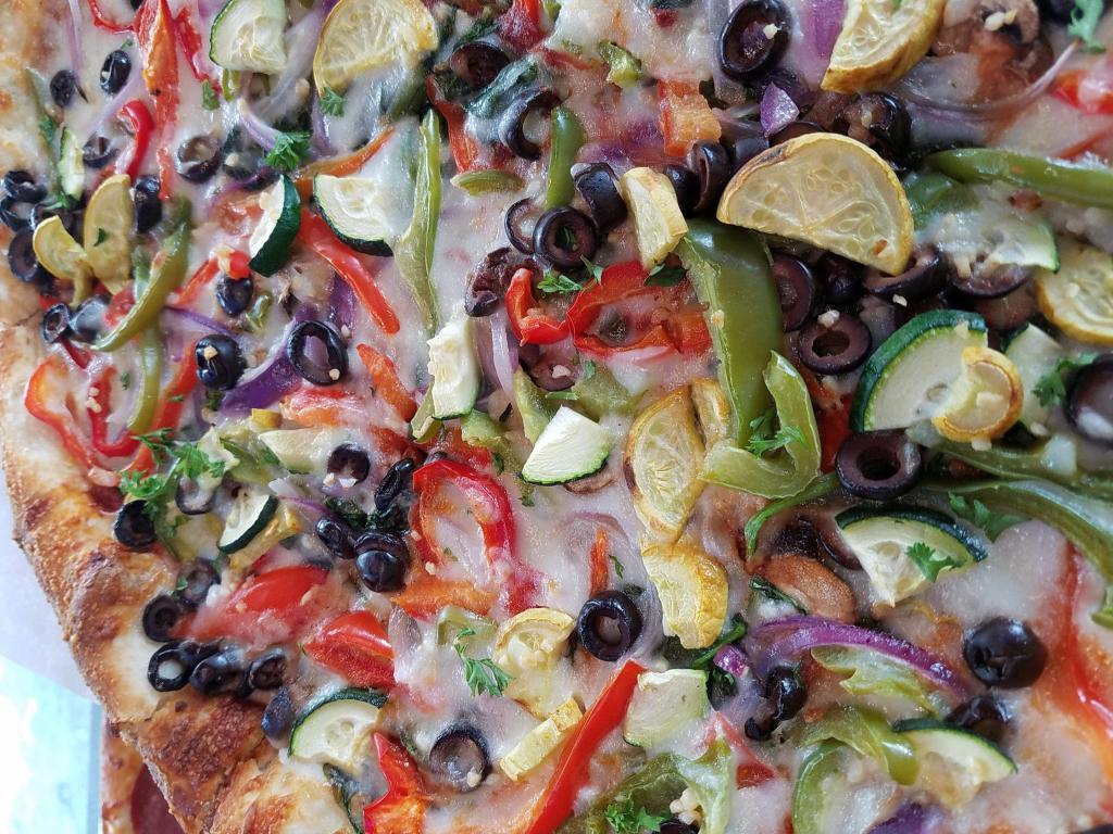 Extreme Veggie Pizza · Roasted red and green peppers, fresh mushrooms, spinach, onions, zucchini, black olives, and chopped garlic.