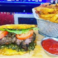 STEAK PATACON SANDWICH · A grilled New York Steak patacon sandwich, topped with chimichurri sauce, lettuce and tomato...