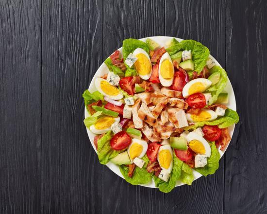 Cobb Salad · Fresh salad made with sliced lean chicken breast with shredded carrots, sliced mushrooms, tomatoes and avocado on a bed of mixed greens.
