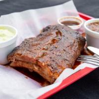 Baby Back Ribs · A cut of meat taken from the top of the rib cage.