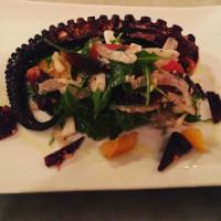Polipo con Patate · Charred octopus over chickpea puree, black squid ink sugo & roasted grape tomatoes. finished...